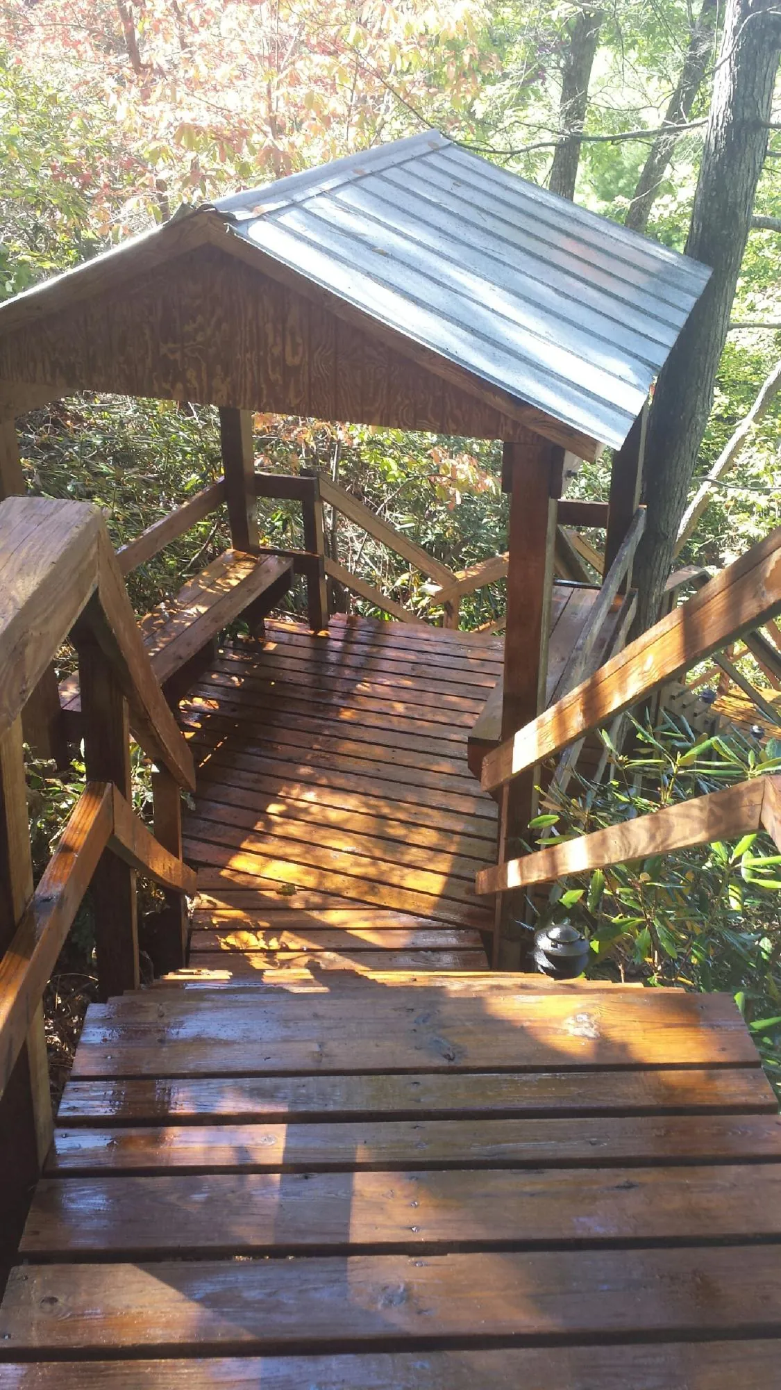 Freshly stained wood walkway and covered shelter with a metal roof in Underhill