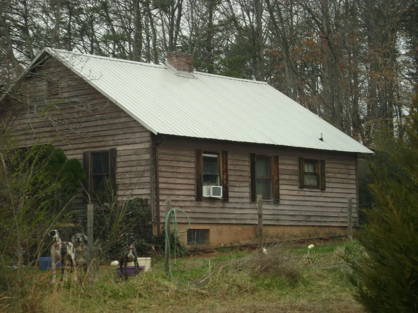 White metal roof on an old wood sided farmhouse, from a Metal Roof Installation job in Underhill